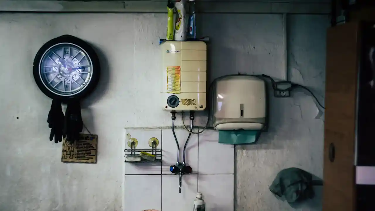 Wall-mounted tankless water heater above a sink