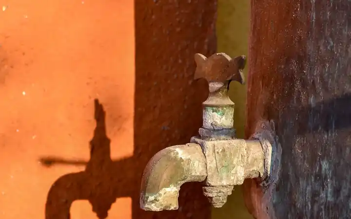Water heater drain valve replacement in La Mirada: old corroded drain spigot