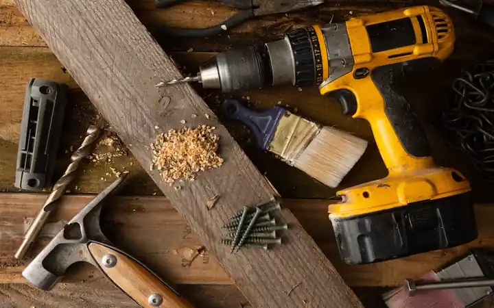 Water heater leak repair cost in La Mirada: plumbing and repair tools on a workbench