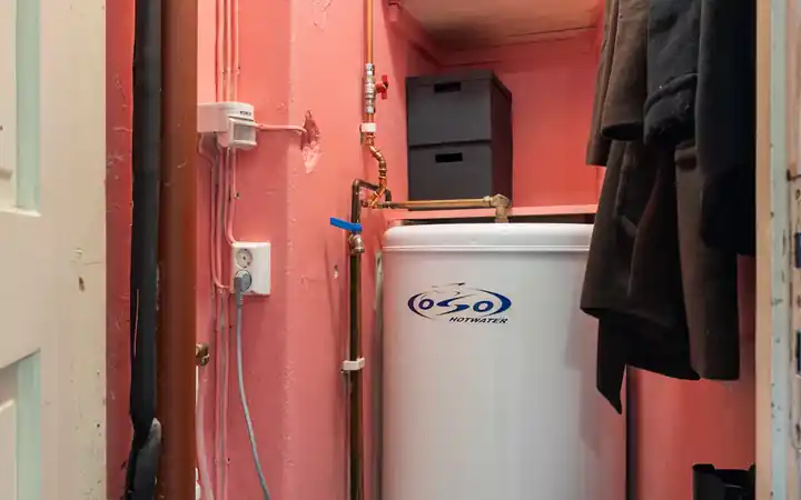 Water heater leaking from bottom in La Mirada: tank water heater in a closet where leaks pool at the base