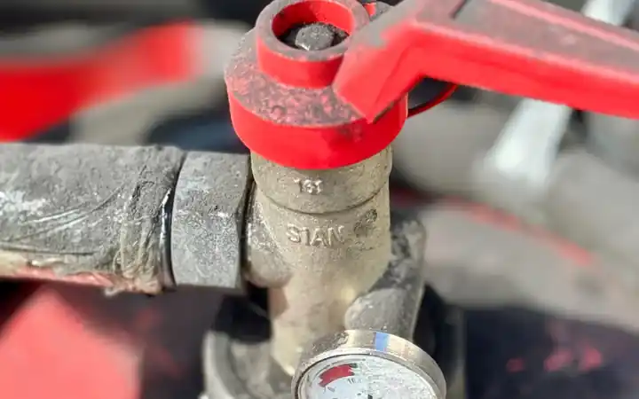 Water heater relief valve replacement in La Mirada: close-up of a valve with a pressure gauge